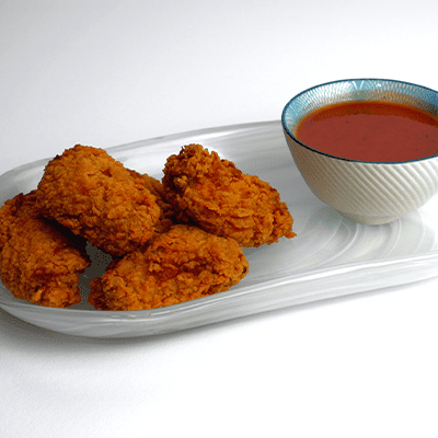 Bruno’s Fast Food fried chicken pieces served with a dipping sauce in Stenhousemuir.